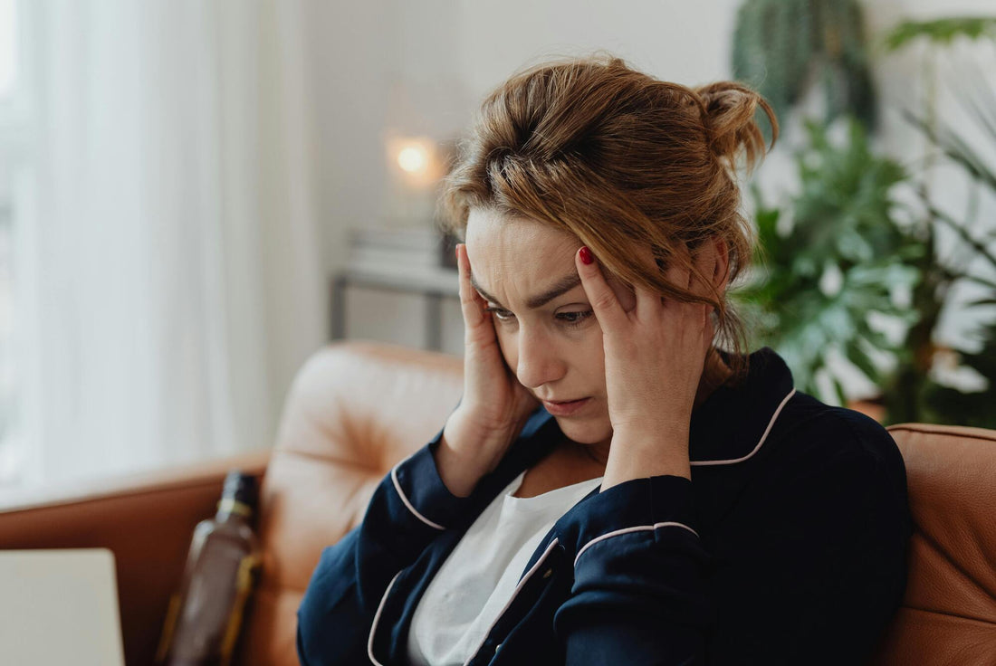 A person sitting quietly looking tired and overwhelmed
