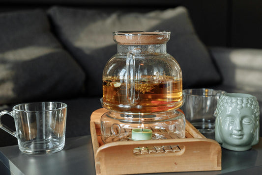 A warm cup of herbal tea on a bedside table