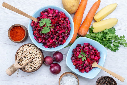 fresh beet salad with sliced vegetables inside blue plates with ingredients